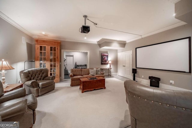 carpeted home theater room featuring crown molding