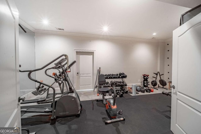 workout area featuring crown molding