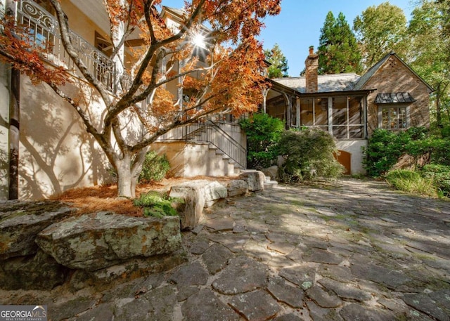 view of side of property featuring a sunroom