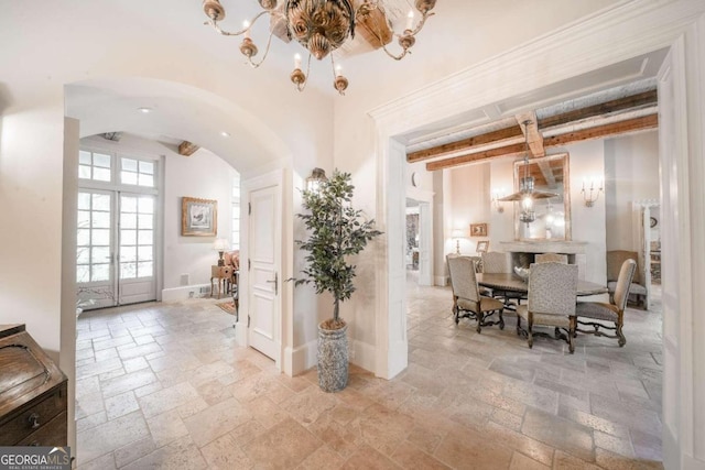 interior space with beamed ceiling and french doors