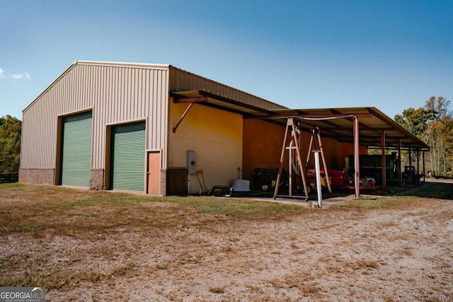 view of outdoor structure featuring a garage and a carport