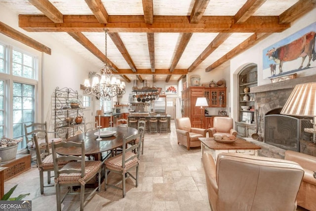 dining space with beam ceiling, built in features, and an inviting chandelier