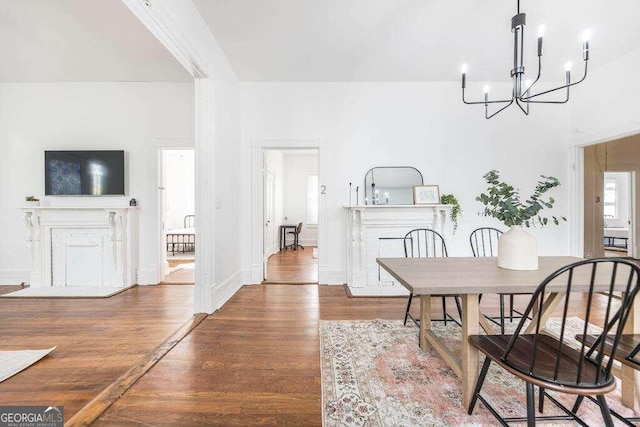 dining space with wood-type flooring and a notable chandelier