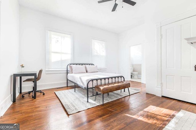 bedroom with ceiling fan, hardwood / wood-style floors, and ensuite bathroom