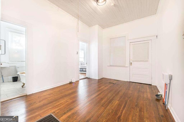 unfurnished room with dark hardwood / wood-style flooring and wood ceiling