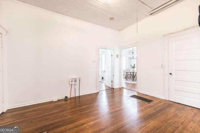 unfurnished room with wood ceiling, dark wood-type flooring, and a towering ceiling