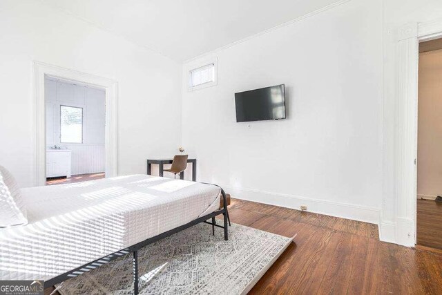 bedroom with dark hardwood / wood-style flooring