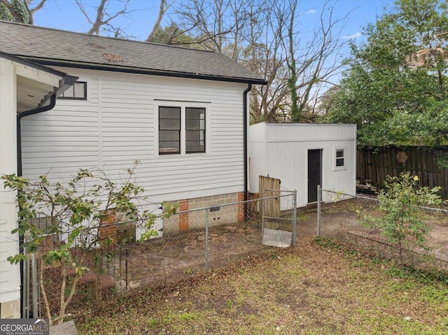 view of side of home with a shed