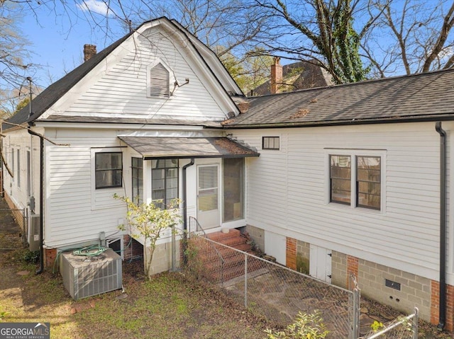 back of house with central AC unit