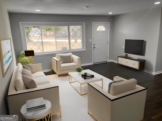 living room featuring dark hardwood / wood-style floors and a textured ceiling