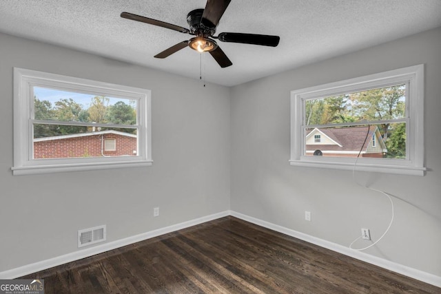 unfurnished room featuring ceiling fan, dark hardwood / wood-style floors, and a textured ceiling