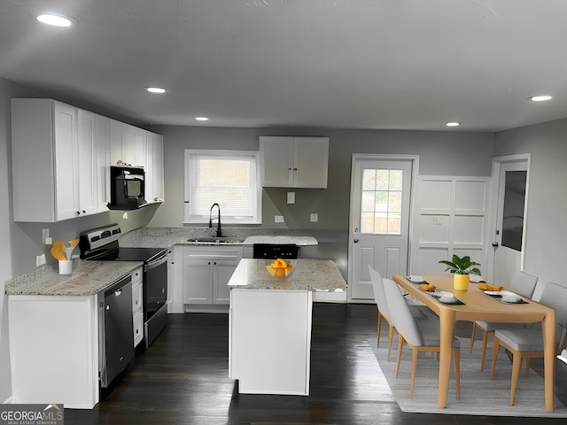 kitchen with white cabinetry, a center island, and black appliances