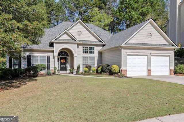 view of front of property featuring a front yard and a garage