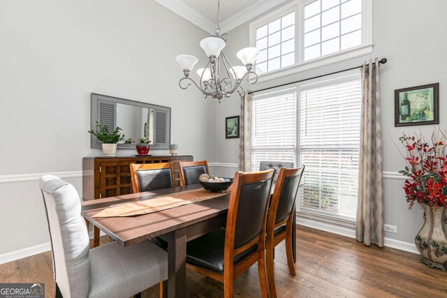 dining area with dark hardwood / wood-style flooring, a chandelier, a high ceiling, and ornamental molding