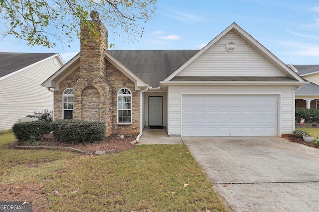 ranch-style house featuring a front yard and a garage