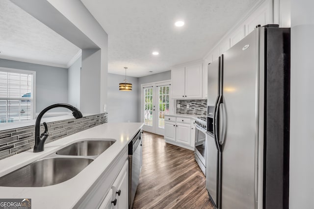 kitchen with backsplash, white cabinets, sink, dark hardwood / wood-style floors, and stainless steel appliances