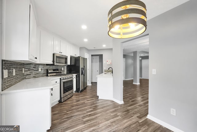 kitchen with white cabinets, stainless steel appliances, dark hardwood / wood-style floors, and sink