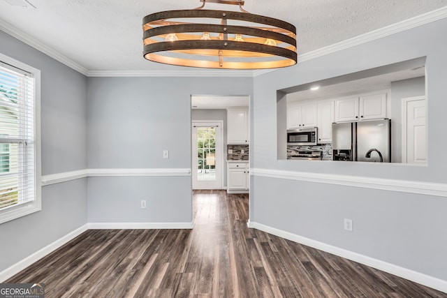 kitchen with a healthy amount of sunlight, white cabinetry, stainless steel appliances, and dark hardwood / wood-style floors