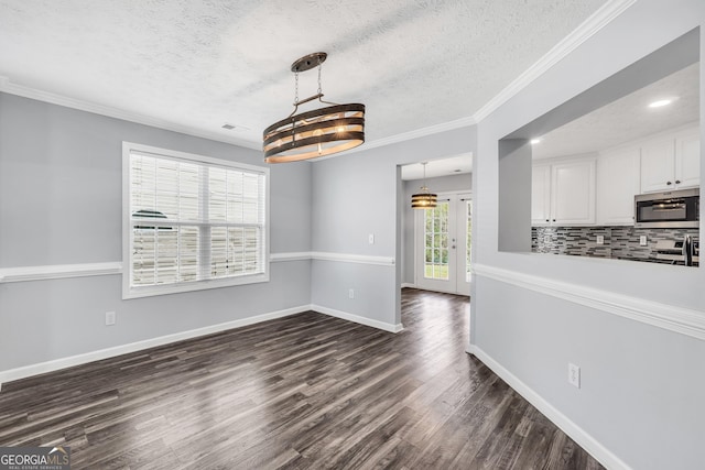 1120 Strath Clyde Way, Mcdonough, GA 30253 - unfurnished dining area with a textured ceiling, dark wood-style floors, ornamental molding, baseboards, and recessed lighting