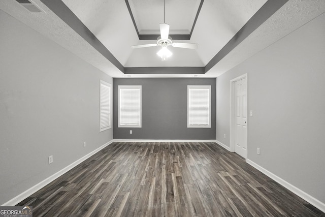 1120 Strath Clyde Way, Mcdonough, GA 30253 - empty room with a raised ceiling, dark wood-style floors, ceiling fan, baseboards, and crown molding
