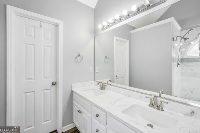 bathroom with vanity and tiled shower