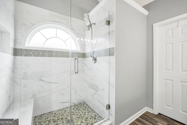 bathroom with wood-type flooring and a shower with shower door