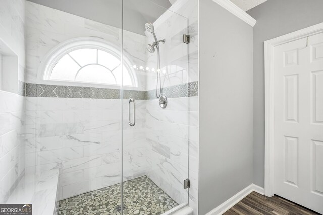 1120 Strath Clyde Way, Mcdonough, GA 30253 - bathroom with a stall shower, wood finished floors, ornamental molding, and baseboards