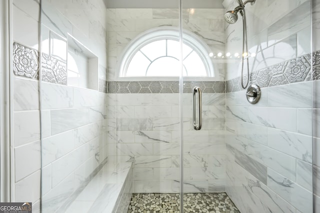 bathroom featuring a shower with door