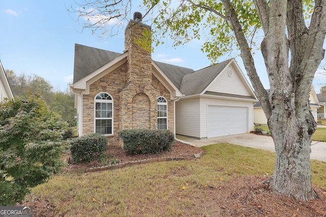 view of front of home with a front yard and a garage