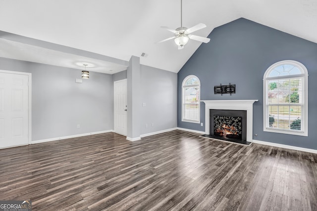 unfurnished living room with dark hardwood / wood-style floors, ceiling fan, and high vaulted ceiling