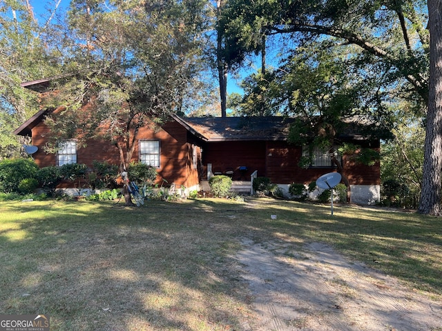 view of side of home featuring a lawn