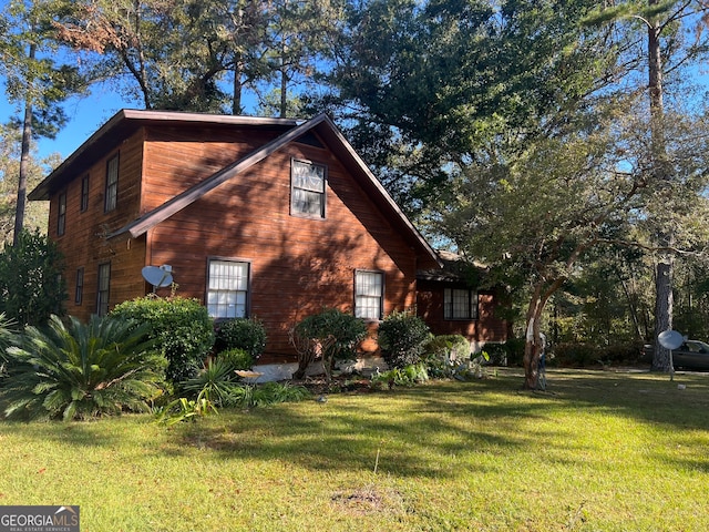 view of home's exterior featuring a yard