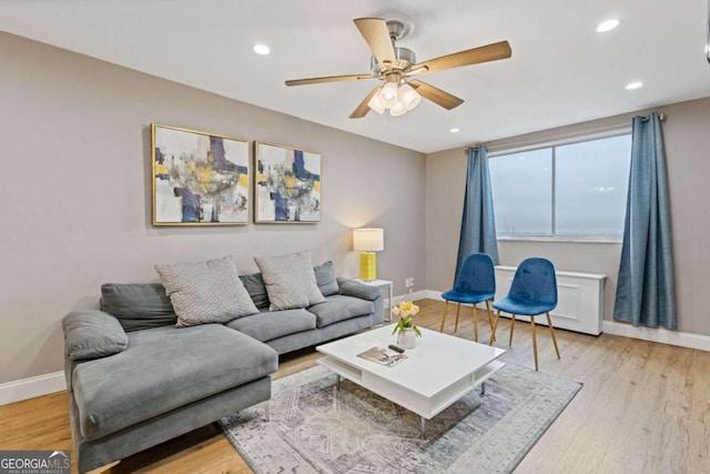 living room with ceiling fan and light wood-type flooring