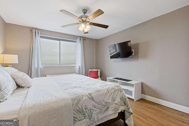 bedroom featuring ceiling fan and light hardwood / wood-style flooring