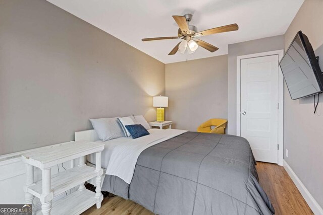 bedroom with light wood-type flooring and ceiling fan