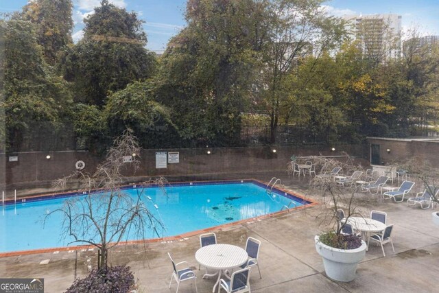 view of swimming pool with a patio