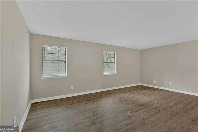 spare room featuring dark hardwood / wood-style floors