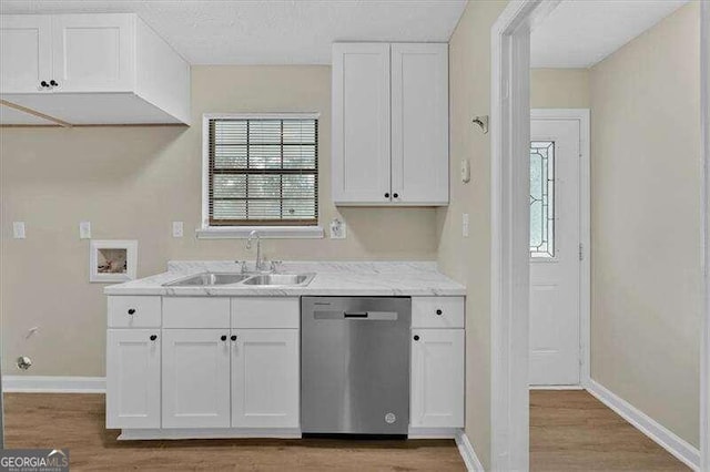 kitchen featuring white cabinetry, dishwasher, light wood-type flooring, and sink