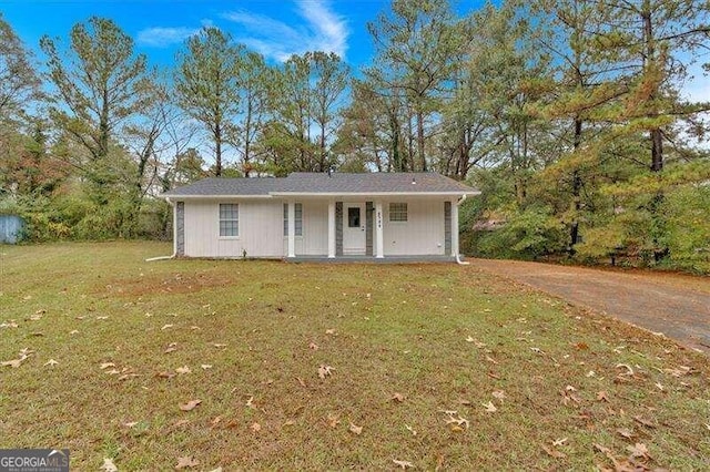 ranch-style house with covered porch and a front lawn