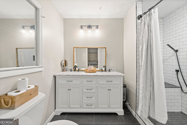 bathroom featuring tile patterned flooring, vanity, toilet, and walk in shower