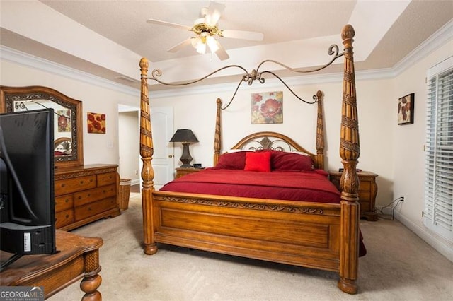 bedroom featuring baseboards, carpet, a tray ceiling, and crown molding