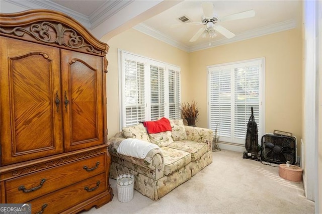 sitting room featuring ceiling fan, carpet, visible vents, and crown molding