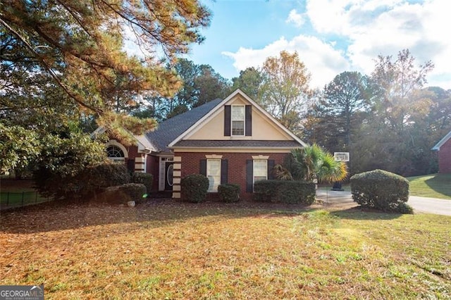 view of front facade with a front lawn and brick siding