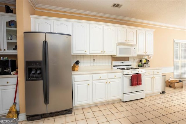 kitchen featuring white appliances, visible vents, white cabinets, light countertops, and crown molding