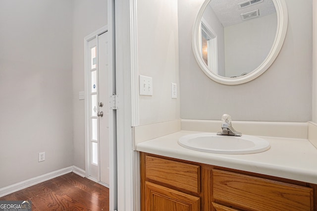 bathroom featuring vanity, a textured ceiling, and hardwood / wood-style flooring