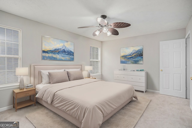 bedroom featuring ceiling fan and light colored carpet