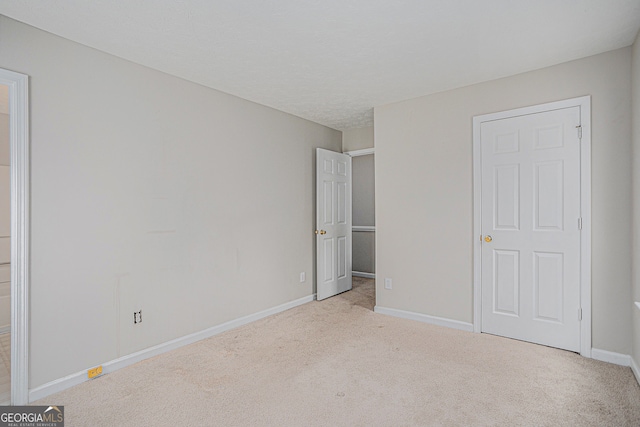 unfurnished bedroom with light carpet