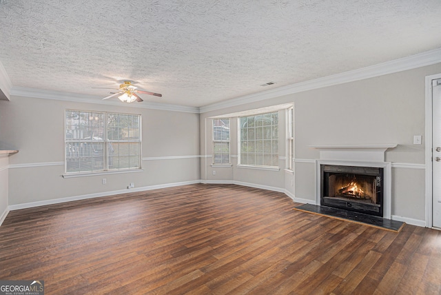 unfurnished living room with ceiling fan, dark wood-type flooring, a textured ceiling, and ornamental molding