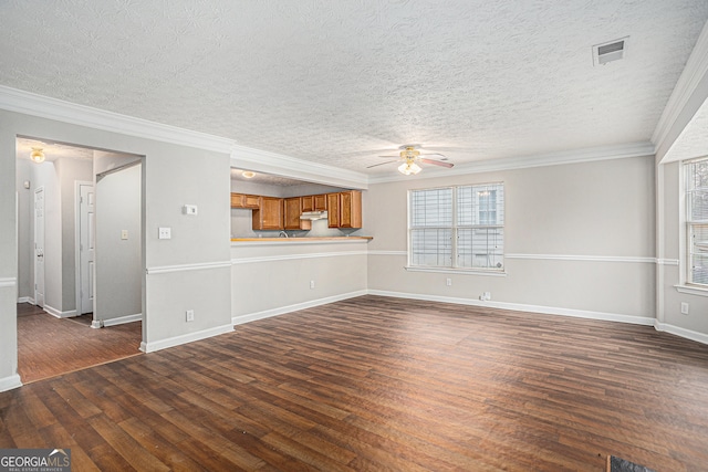 unfurnished living room with ceiling fan, dark hardwood / wood-style flooring, a textured ceiling, and ornamental molding