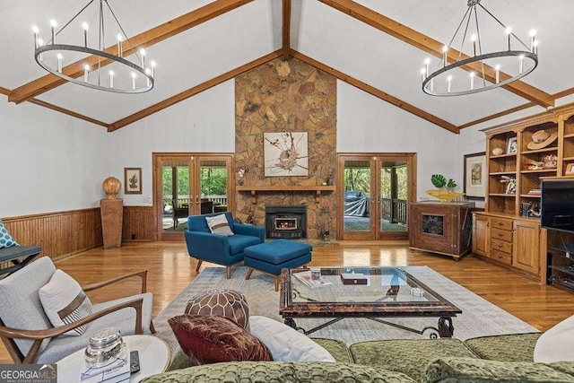 living room with a wealth of natural light, french doors, and high vaulted ceiling